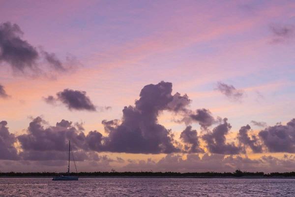 Bahamas, Exuma Is Sailboat anchored at sunset